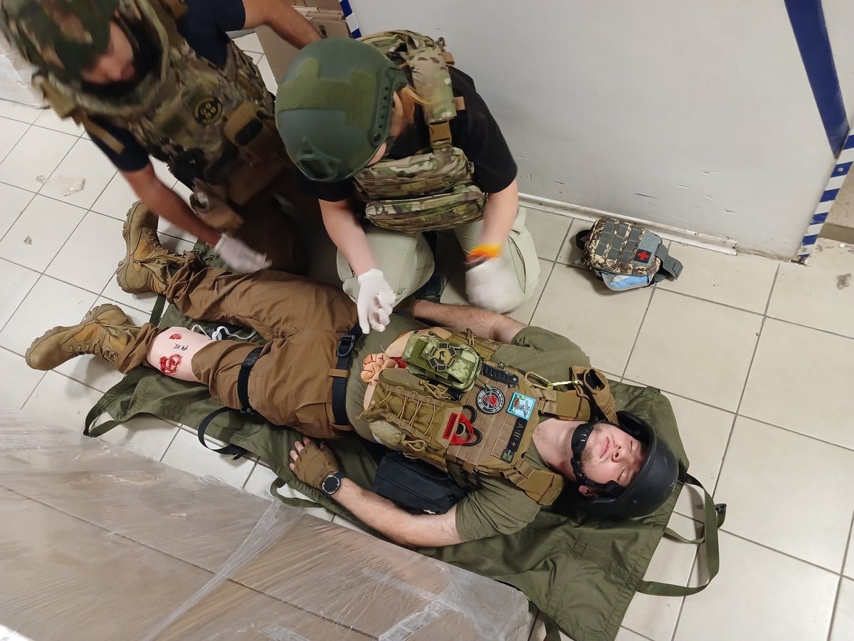 Humanitarian response team practising combat lifesaver skills