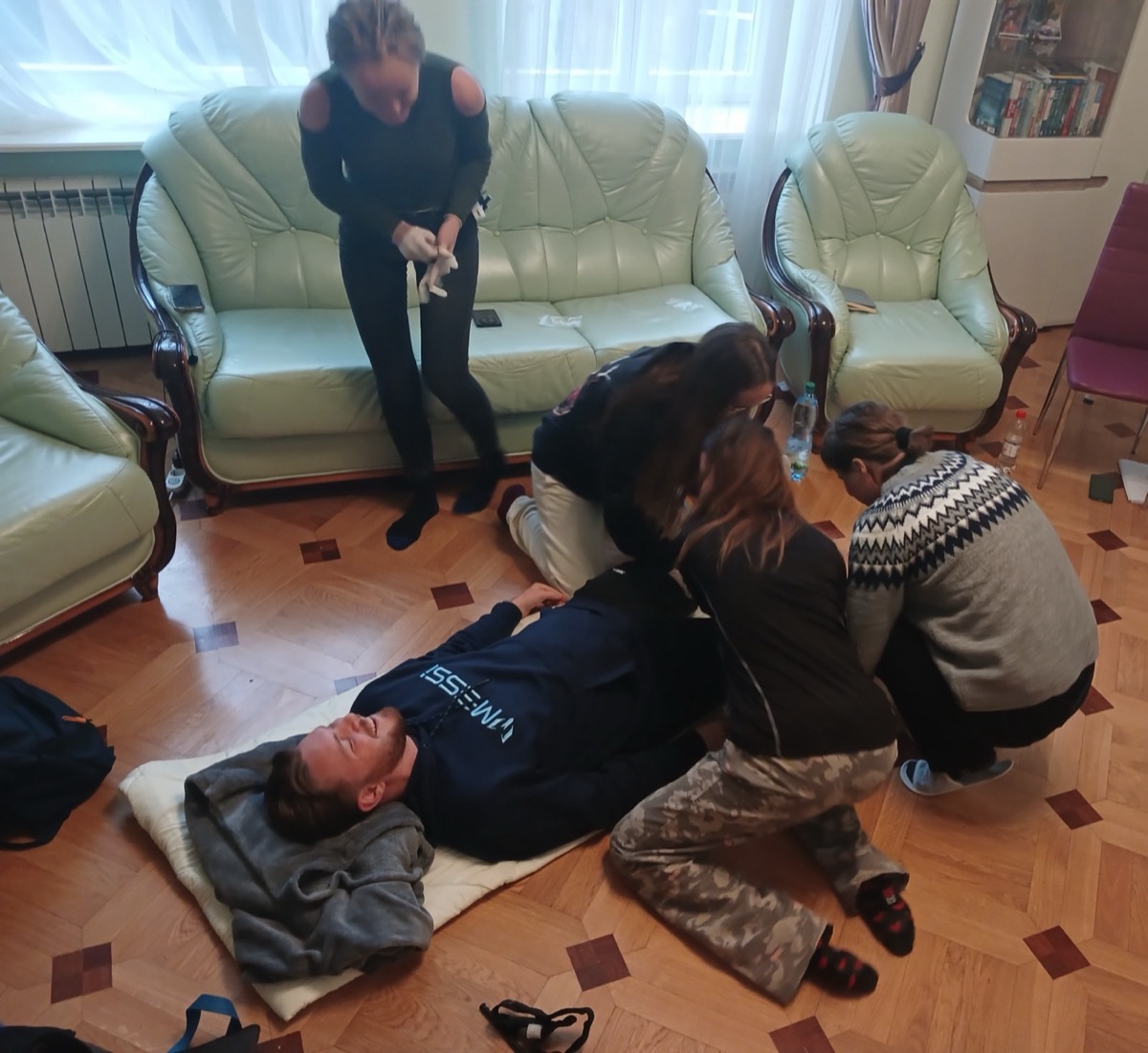 Trainees assessing a simulated casualty during the 4-day TacMed course in Lviv